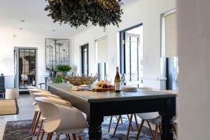 a large dining room with a table and chairs at Villa Le Roc Kleinmond Accommodation in Kleinmond