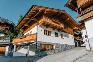 a house with wooden balconies on the side of it at Chalet Waschkuchl in Alpbach