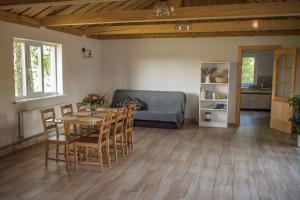 a living room with a table and chairs and a couch at Dizrobeznieki in Veldze