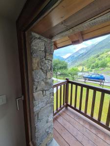 a door to a balcony with a view of a mountain at Cachettes in La Salle