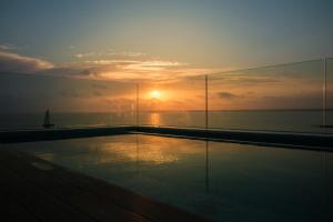 
a sunset with a view of the ocean at Hotel Villa Chiquita in Colònia de Sant Jordi
