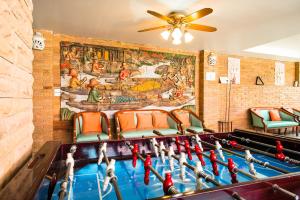 a ping pong table in a room with a mural at Sathorn Saint View Serviced Apartment in Bangkok