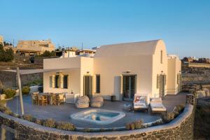 a villa with a swimming pool in the desert at Villa Vinea Santorini in Imerovigli