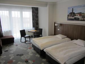 Łóżko lub łóżka w pokoju w obiekcie Hotel Europa