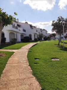 a stone path in front of a building at APARTAMENTOS SON BOU Z5 in Son Bou