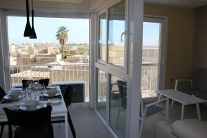 A restaurant or other place to eat at Wileg 4A Luxury Studio Apartment with Shared Swimming Pool.