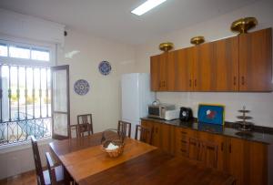 a kitchen with wooden cabinets and a wooden table at Villa Victoria in Vallobal