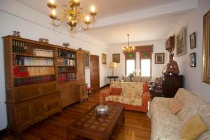a living room with a couch and a book shelf at Villa Victoria in Vallobal