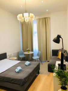 Un dormitorio con una cama, un sofá y una mesa. en In My Style Apartman, en Budapest