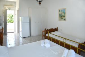 Ένα ή περισσότερα κρεβάτια σε δωμάτιο στο Sani Kasimis