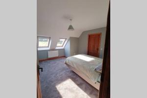 a bedroom with a bed in the corner of a room at Self catering upstairs apartment at Tradcottage in Sligo