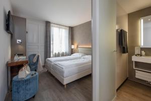Postel nebo postele na pokoji v ubytování Hôtel du Théâtre, Boutique Hôtel