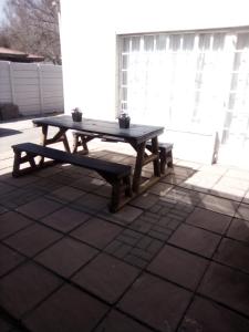 a wooden picnic table sitting on a patio at The Eden Lodge Boksburg in Boksburg