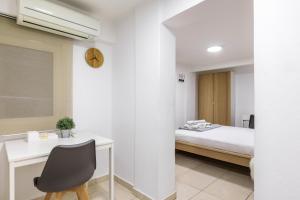 a bedroom with a bed and a desk and a chair at Αpartment in Rotonda (heart of Thessaloniki) in Thessaloniki