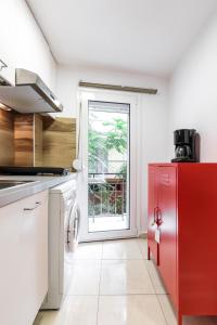 a kitchen with a red refrigerator and a window at Αpartment in Rotonda (heart of Thessaloniki) in Thessaloniki