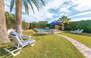 a couple of chairs and an umbrella next to a pool at Stunning Home In El Campello With Wifi in El Campello