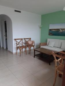 a living room with a couch and chairs and a table at APARTAMENTOS SON BOU Z5 in Son Bou