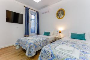 Łóżko lub łóżka w pokoju w obiekcie TACITA Family Home by Cadiz4Rentals