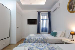 Łóżko lub łóżka w pokoju w obiekcie TACITA Family Home by Cadiz4Rentals