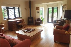 a living room with a couch and a coffee table at Ashwood Holiday Cottage. in Ashford