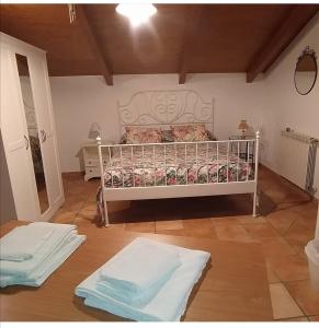 a bedroom with a white bed in a room at La corte del Campo in Cava deʼ Tirreni