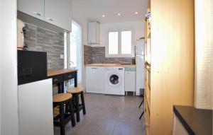 a kitchen with a washer and dryer in it at Nice Home In Petreto Bicchisano With Heated Swimming Pool in Petreto-Bicchisano