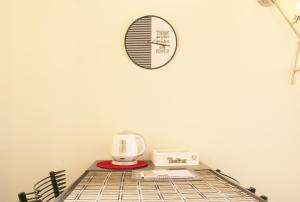 Cette chambre dispose d'un lit avec une horloge murale. dans l'établissement BnButler - Navigli Apartment - Vicolo Lavandai, à Milan