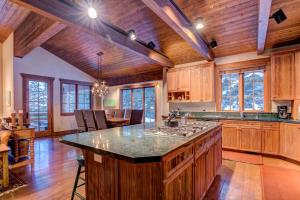 a large kitchen with wooden cabinets and a large island at 7650 Sterling Drive in Park City