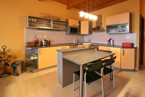 a kitchen with a table and some chairs in it at Apartmány Doky Holiday in Lipno nad Vltavou