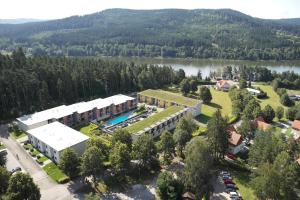an aerial view of the resort with a lake at Apartmány Doky Holiday in Lipno nad Vltavou