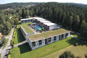 an aerial view of a large building with a yard at Apartmány Doky Holiday in Lipno nad Vltavou