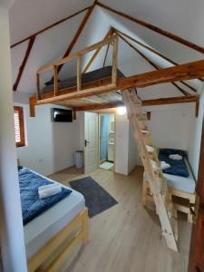 a room with two bunk beds and a ladder at Konak Dobri Potok in Krupanj