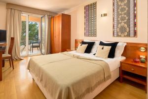 Säng eller sängar i ett rum på Hotel Villa Andrea