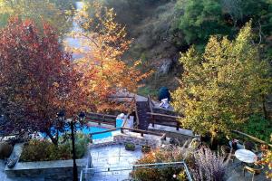 an overhead view of a pool in a park with trees at Viraggas Traditional hotel in Vrástama