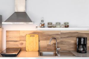 a kitchen with a sink and a counter top at Sky Studios in Thessaloniki