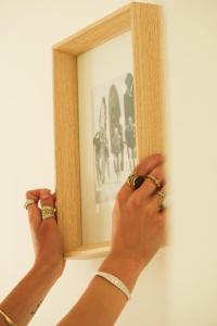 a person holding a picture in a picture frame at Hospedium Hostel República Surf House in Ericeira