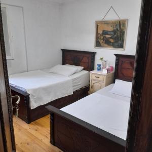 - une chambre avec 2 lits et une photo sur le mur dans l'établissement Smoha Zahran Haus (Private rooms or Private Apartment), à Alexandrie