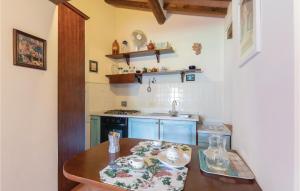 a small kitchen with a wooden table and a sink at La Spizzica 3 in Baccano