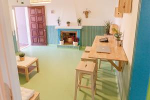 a room with a table with a laptop on it at Hospedium Hostel República Surf House in Ericeira