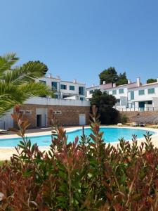 a view of a swimming pool with buildings in the background at Alvor Village By The Sea in Alvor