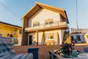 a house with a balcony and a patio at Hospedium Hostel República Surf House in Ericeira