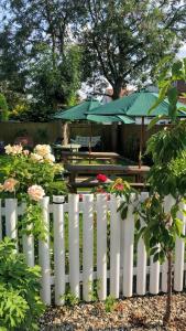 a white picket fence with a table and umbrella at Oxford Guest House in Oxford