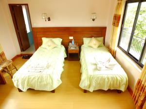 Una cama o camas en una habitación de Hotel Greenland