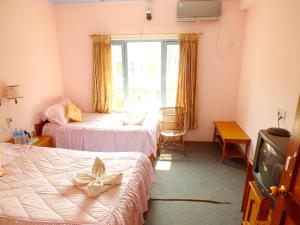 Una cama o camas en una habitación de Hotel Greenland
