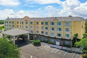 an aerial view of a hotel with a parking lot at Comfort Suites Near Universal Orlando Resort in Orlando