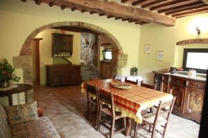 cocina y comedor con mesa y sillas en Agriturismo Tisignana, en Roccastrada