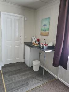 a small kitchen with a counter and a sink at Royal Albion Walton in Walton-on-the-Naze