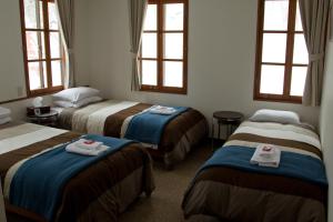 En eller flere senge i et værelse på Hakuba House