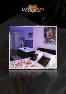 a picture of a bedroom with a bed with pillows at Love room l'escale Castellane in Marseille