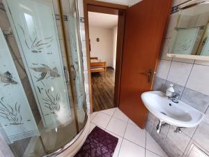 a bathroom with a shower and a sink at Apartments Topalović in Kostrena +38 photos